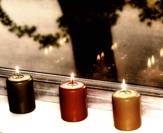 candles lined up on a windowsill