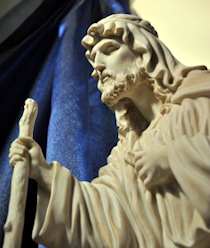 Statue of Saint Joseph with blue curtain in back