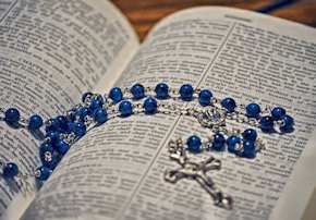 rosary on a Bible